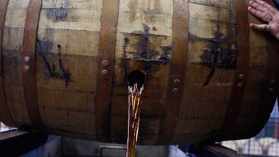 CLERMONT, KY - JANUARY 13:  Knob Creek Single Barrel Bourbon is drained at the Jim Beam Bourbon Distillery on January 13, 2014 in Clermont, Kentucky. Japanese company Suntory Holdings acquired Beam Inc. for $13.6 Billion in a deal announced Monday. Beam is the owner of Jim Beam and Maker's Mark bourbon brands and was purchased at $83.50 per share. (Photo by Luke Sharrett/Getty Images)
